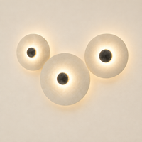 Ashby Halo Disc Wall Light – switched on, studio view