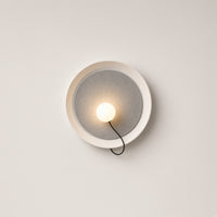 Chiltern Disc Wall Light – studio photo, lit, on a cream background