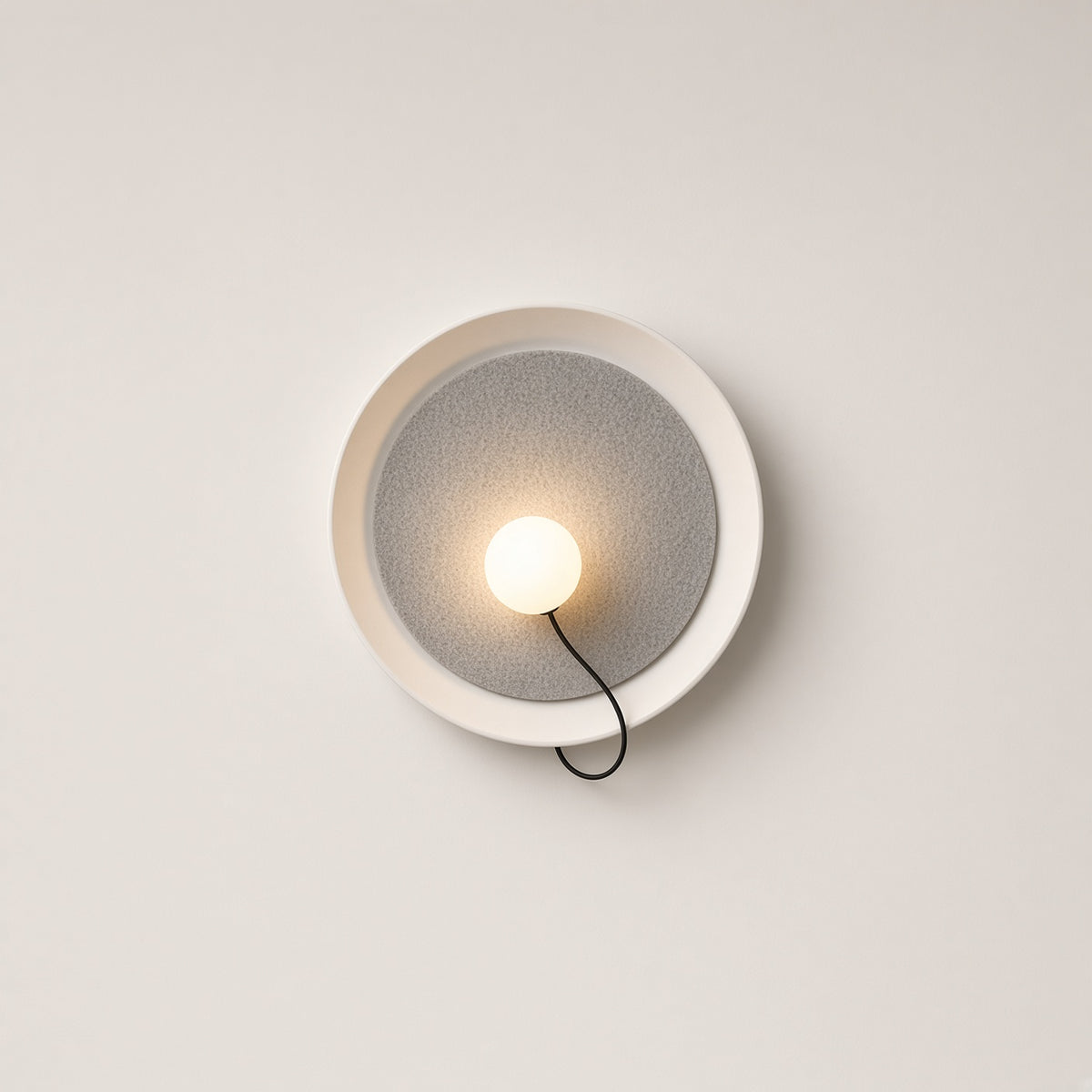 Chiltern Disc Wall Light – studio photo, lit, on a cream background