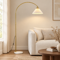 Fairford Pleated Arc Floor Lamp – beside a sofa