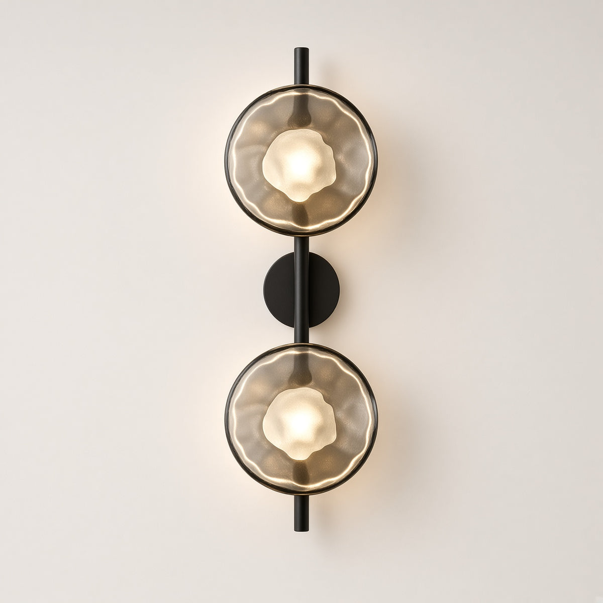 Kelso Double Disc Wall Light – studio photo, lit, on a cream background