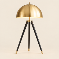 Kersey Gold Dome Tripod Table Lamp – switched on, studio view