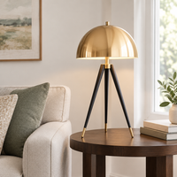 Kersey Gold Dome Tripod Table Lamp – on a side table by a sofa